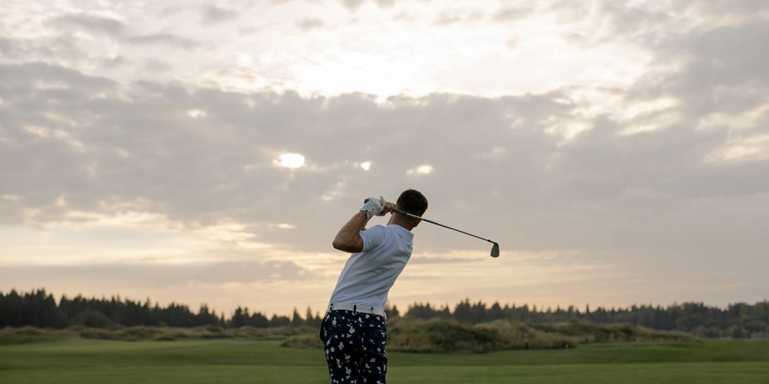 Golfer hitting a golf ball