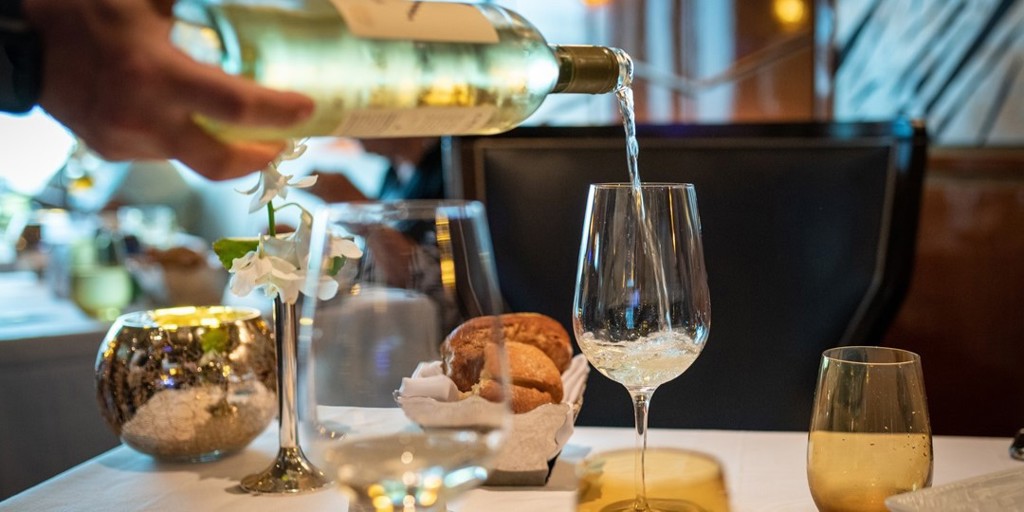 White wine being poured into a wine glass