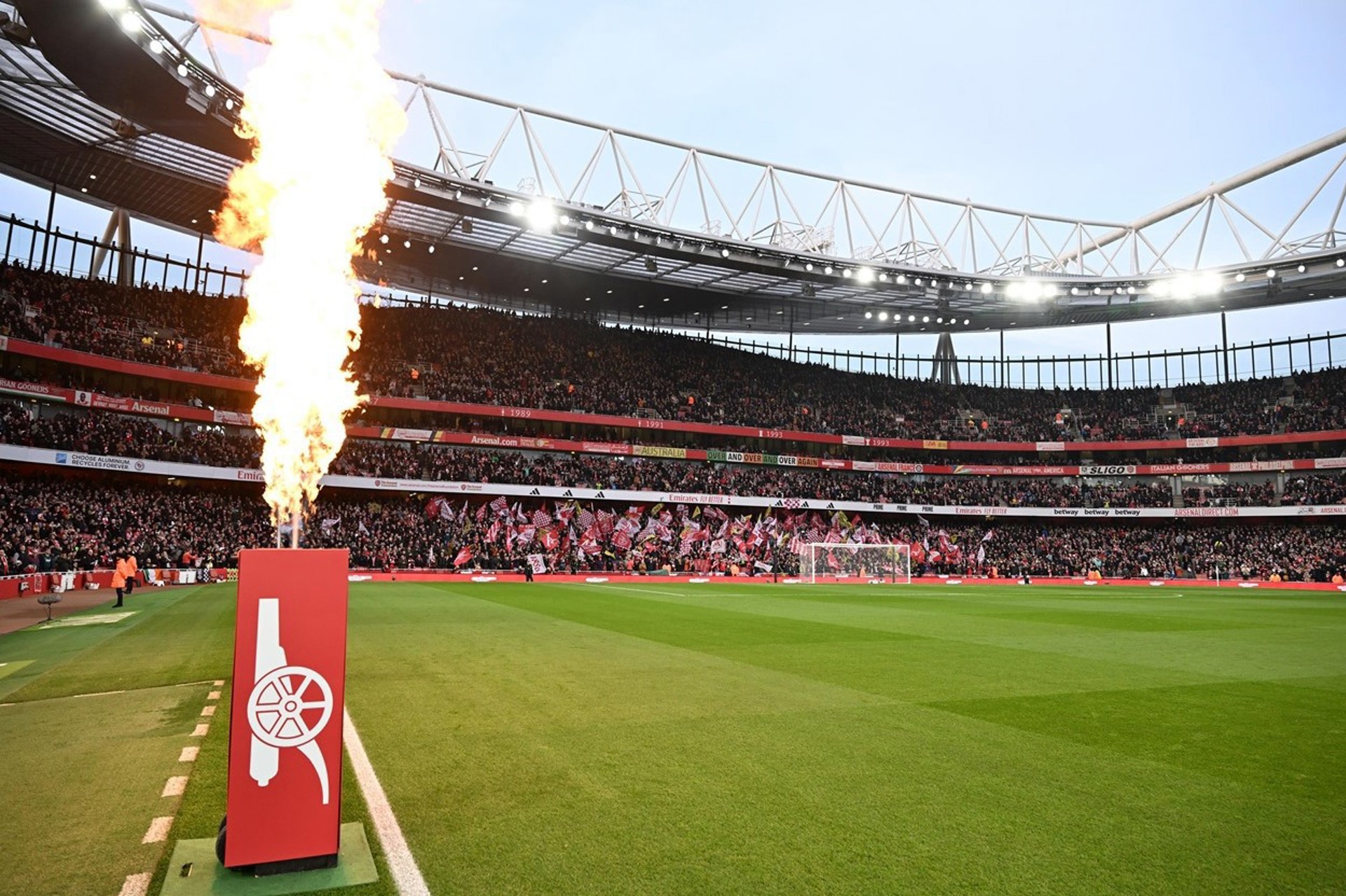 Flame unit alight beside the pitch at Emirates Stadium