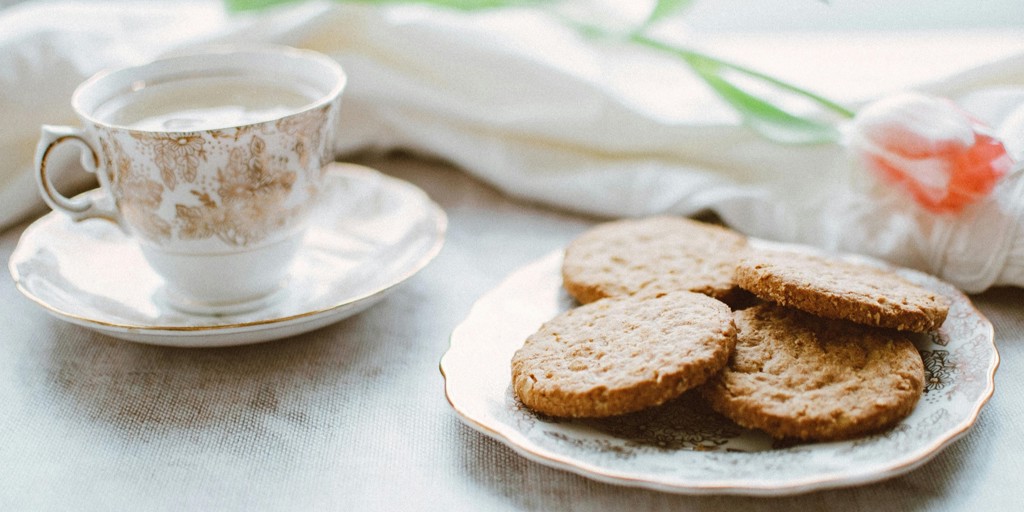 Cup of tea and biscuits on a plate